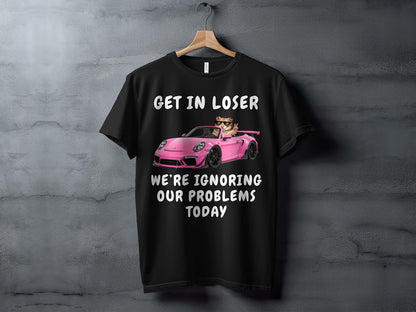Black t-shirt with a cat in a pink sports car, text "GET IN LOSER WE'RE IGNORING OUR PROBLEMS TODAY".