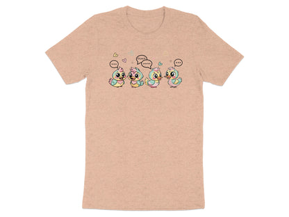 Four cartoon ducklings with speech bubbles, one saying "Quack," are on a peach t-shirt.
