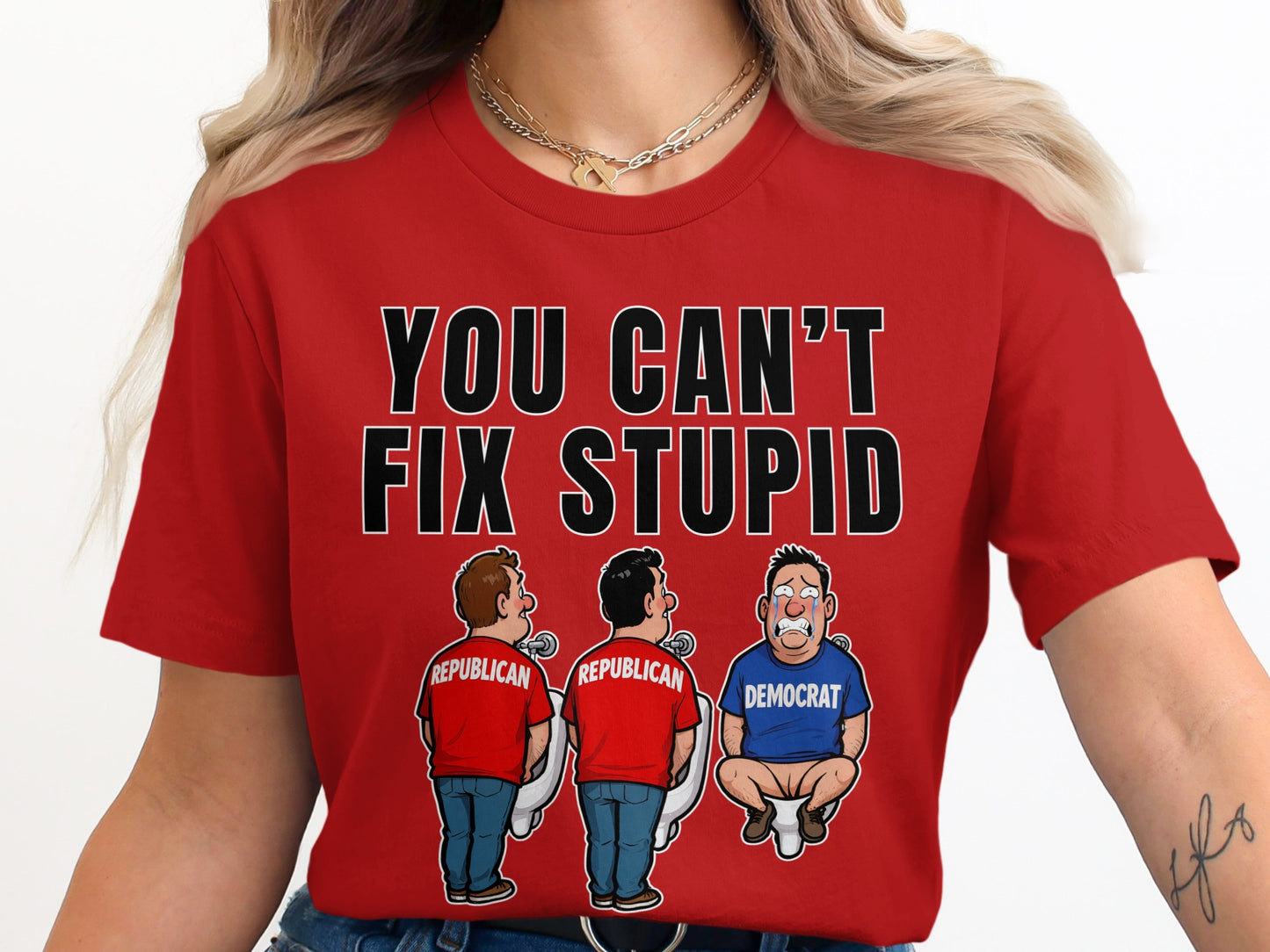Red shirt with text "YOU CAN'T FIX STUPID" and cartoon of Republicans at urinals, Democrat crying on toilet.
