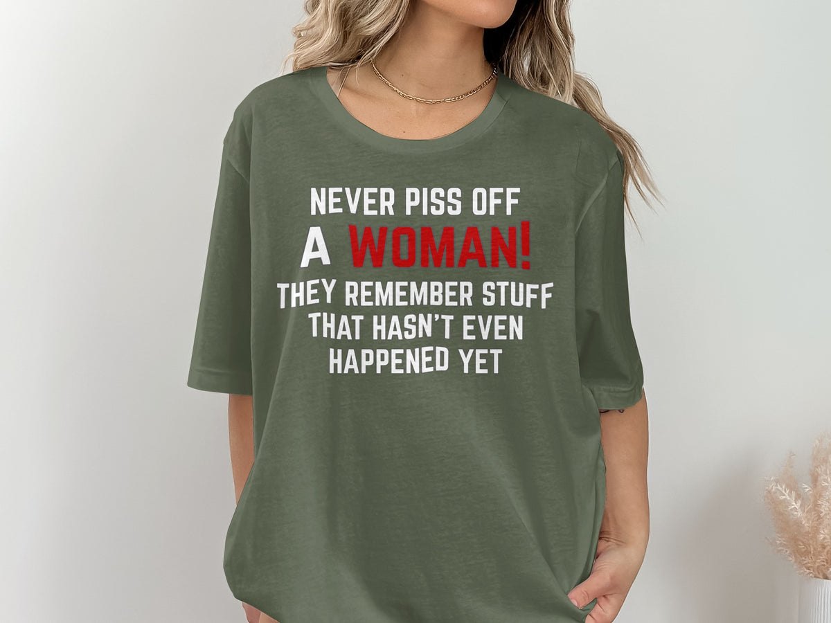 Green t-shirt with white text: "Never piss off a woman! They remember stuff that hasn't even happened yet."