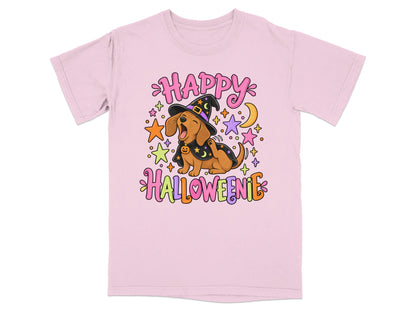 Pink t-shirt with cartoon dachshund wearing witch hat and cape, saying Happy Halloweenie.