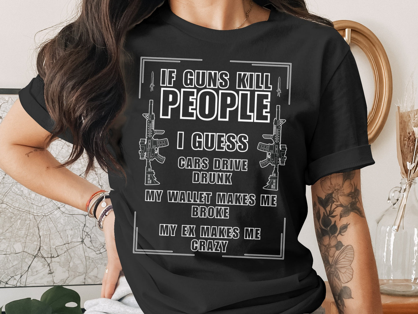 Black t-shirt with text "If guns kill people I guess cars drive drunk"