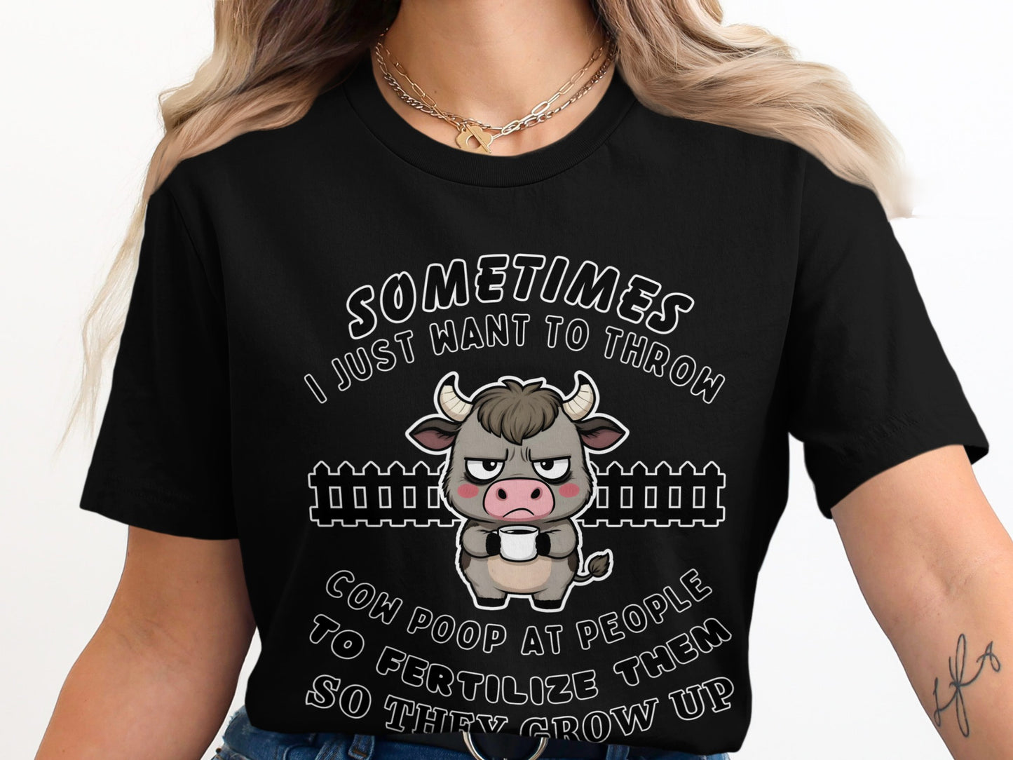 Black t-shirt with a grumpy animated cow and text: "Sometimes I just want to throw cow poop at people to fertilize them so they grow up."