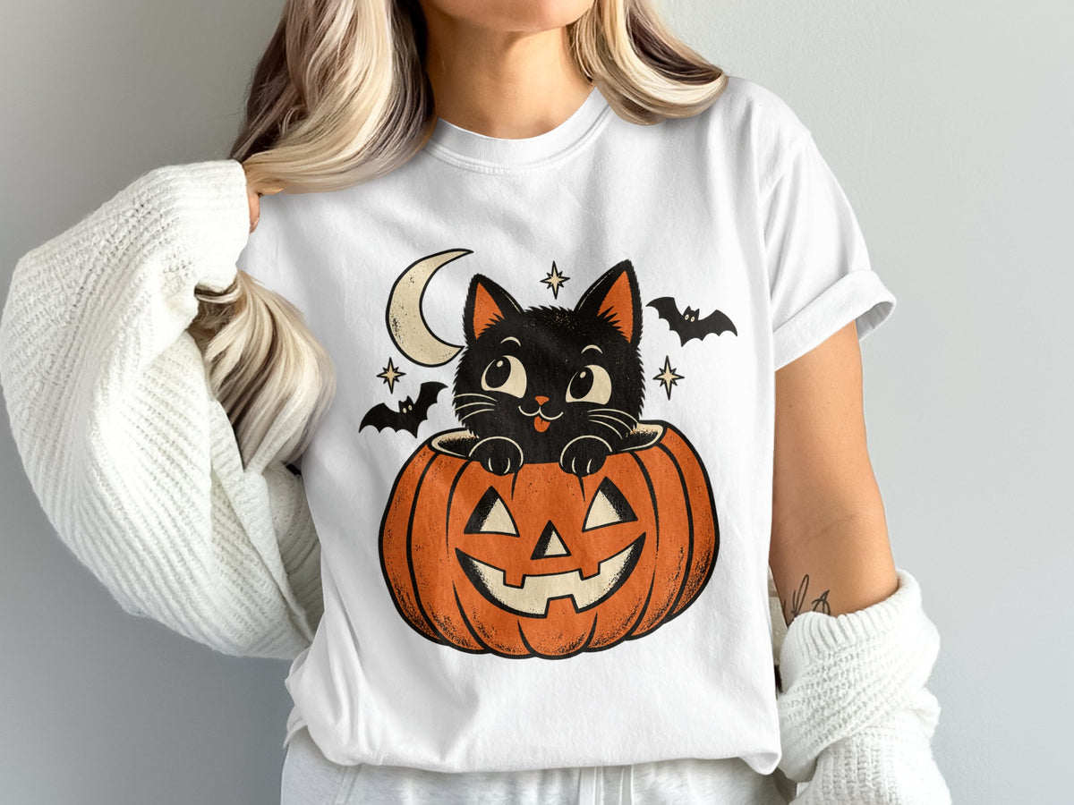 Black cat peeking out of a jack-o'-lantern with bats and stars.