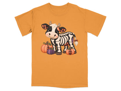 Skeleton cow with pumpkins, wearing plaid accents on an orange t-shirt.
