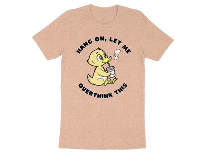 Peach t-shirt with a cartoon duck drinking from a cup with text "Hang on, let me overthink this".