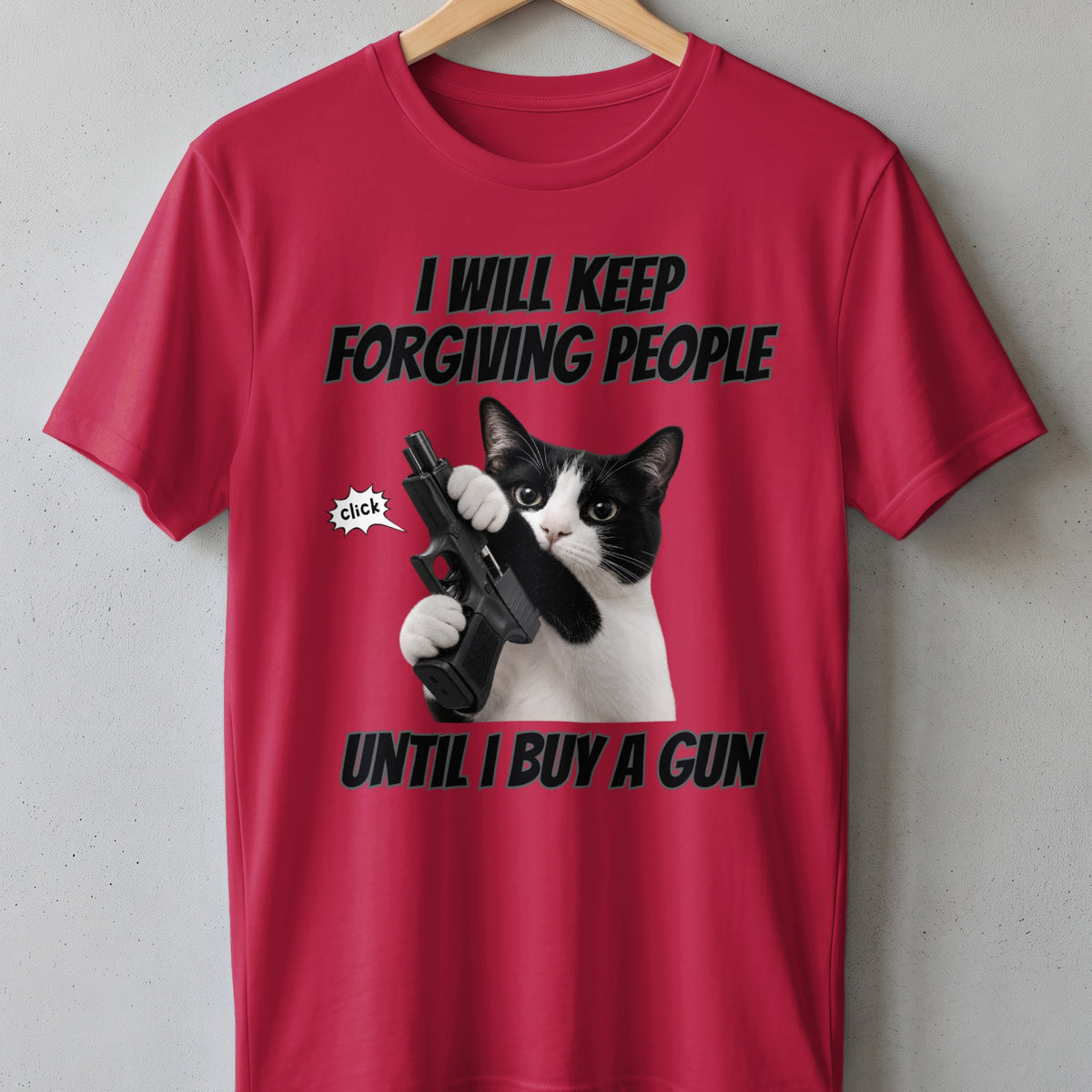Black and white cat holding a gun on a red t-shirt with text.