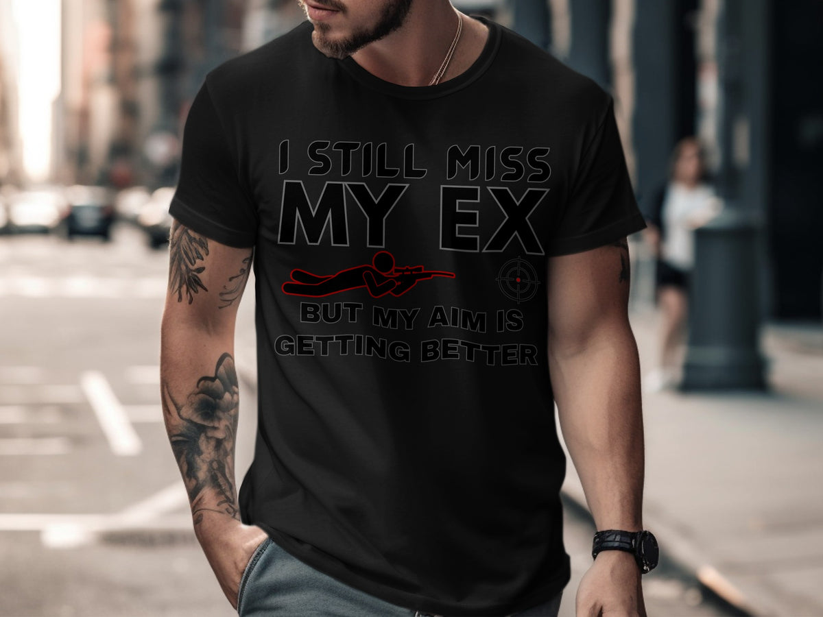 Black t-shirt with text "I still miss my ex but my aim is getting better" and graphic.