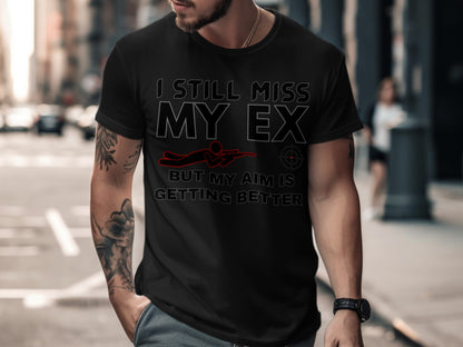 Black t-shirt with text "I still miss my ex but my aim is getting better" and graphic.