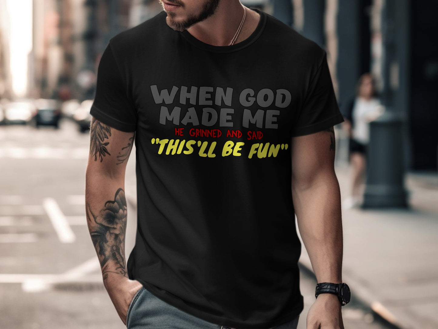 Black t-shirt with "When God Made Me, He Grinned And Said 'This'll Be Fun'" text.
