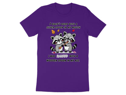 Purple t-shirt with two raccoons and text about being raised with a wooden spoon.