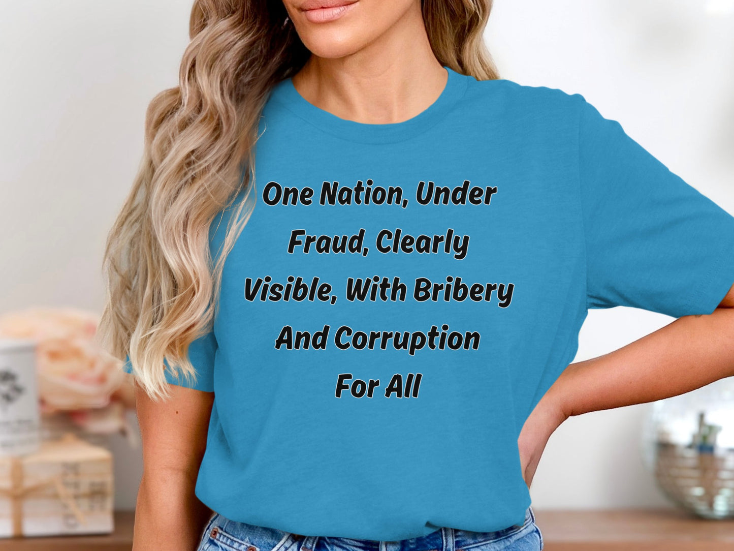 Blue t-shirt with black text reading "One Nation, Under Fraud, Clearly Visible, With Bribery And Corruption For All".