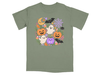 Green t-shirt with cute Halloween cartoon graphics featuring pumpkins, ghosts, bats, and a cauldron.
