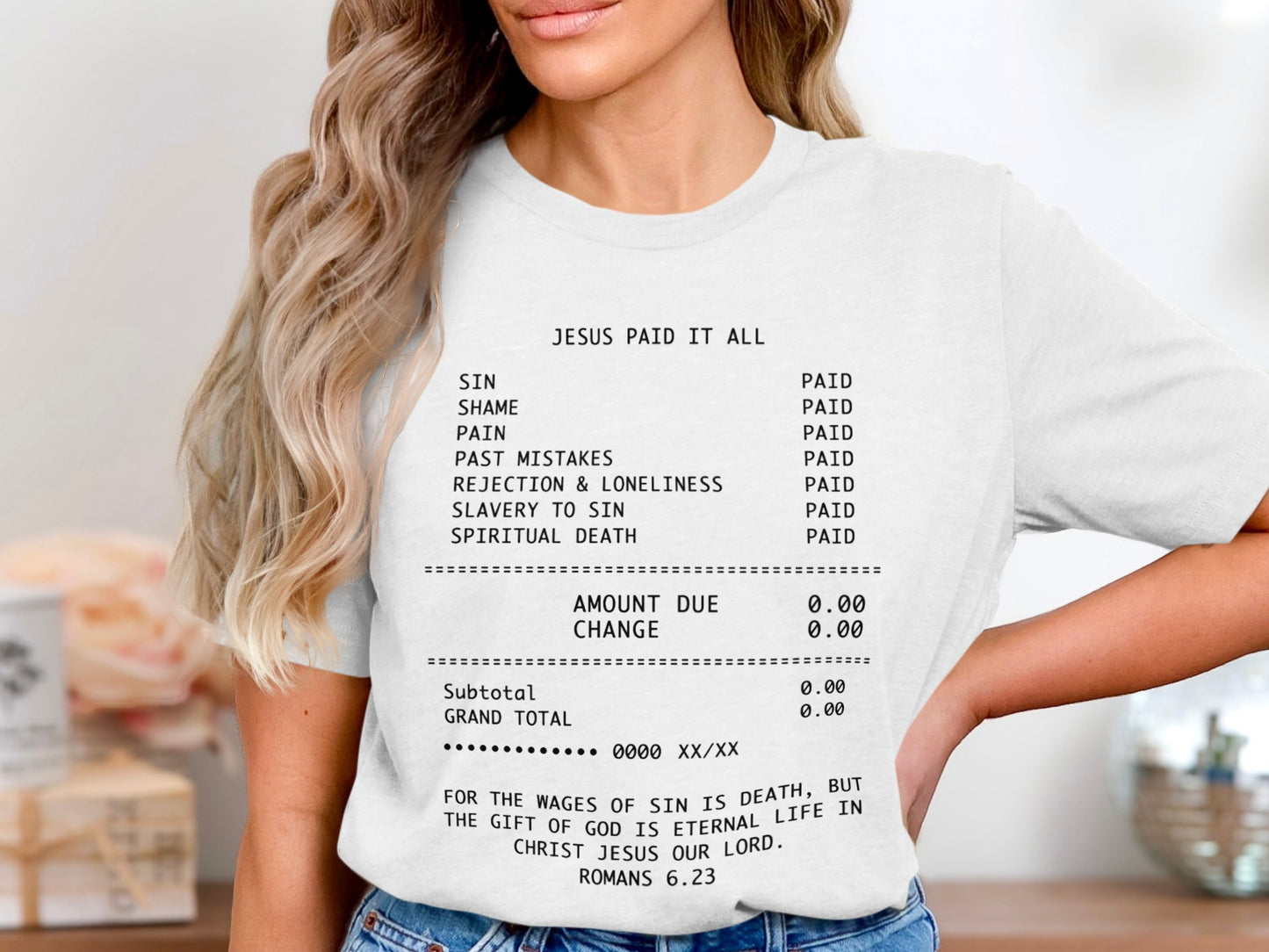 White t-shirt with black text listing "Jesus Paid It All" with sins and their paid status.