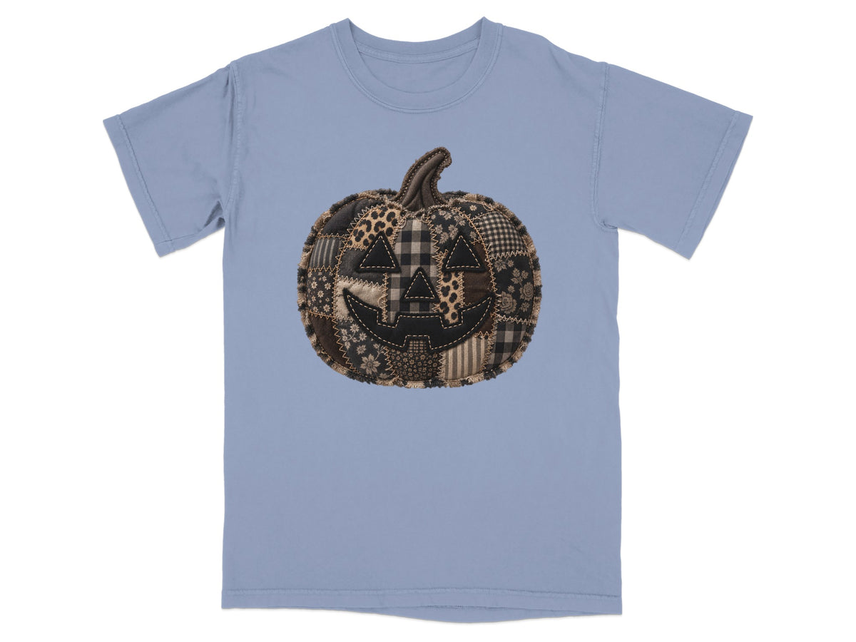 Light blue t-shirt with a patchwork jack-o'-lantern design.