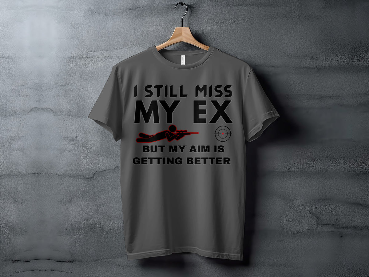 Gray t-shirt with text "I STILL MISS MY EX BUT MY AIM IS GETTING BETTER".