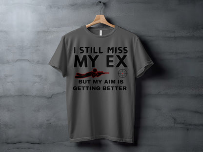 Gray t-shirt with text "I STILL MISS MY EX BUT MY AIM IS GETTING BETTER".