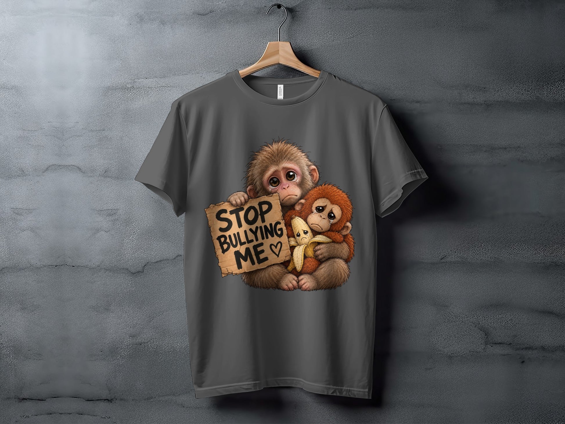 Two sad monkeys holding a sign that says "STOP BULLYING ME".
