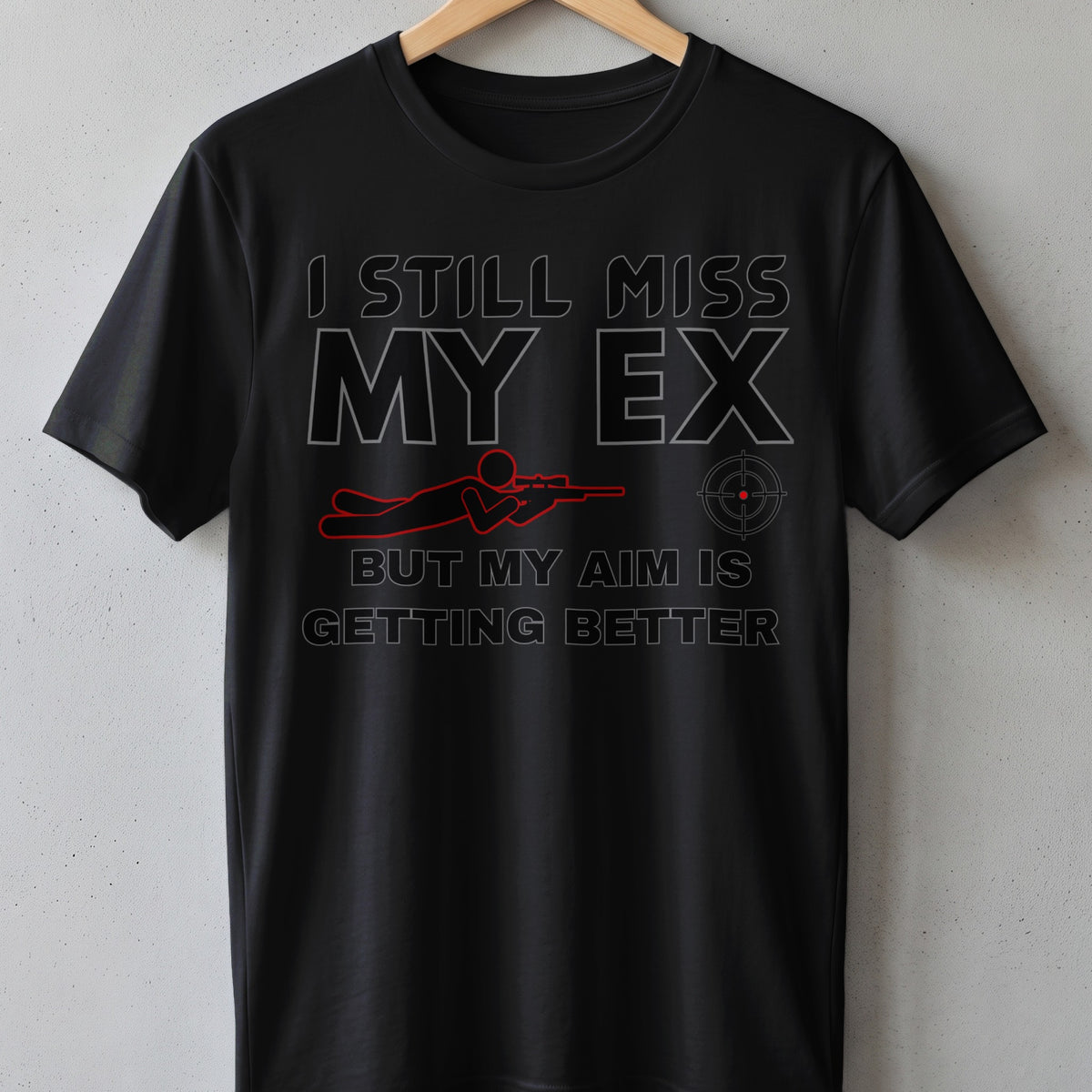 Black t-shirt with text "I still miss my ex, but my aim is getting better".
