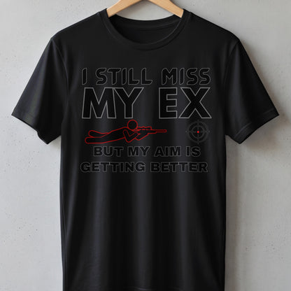 Black t-shirt with text "I still miss my ex, but my aim is getting better".