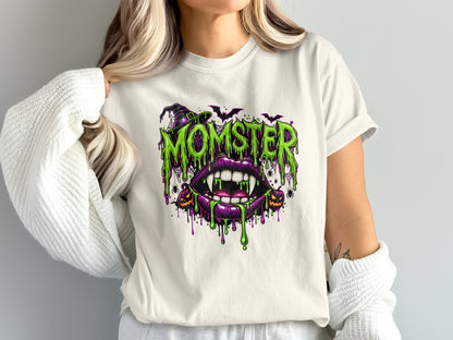 White t-shirt with dripping "MOMSTER" text, fangs, and Halloween icons.