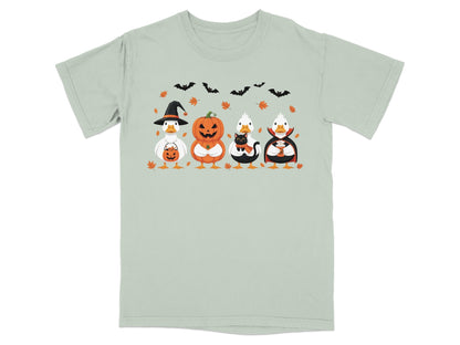 Four ducks in Halloween costumes: witch, pumpkin, cat, and vampire.