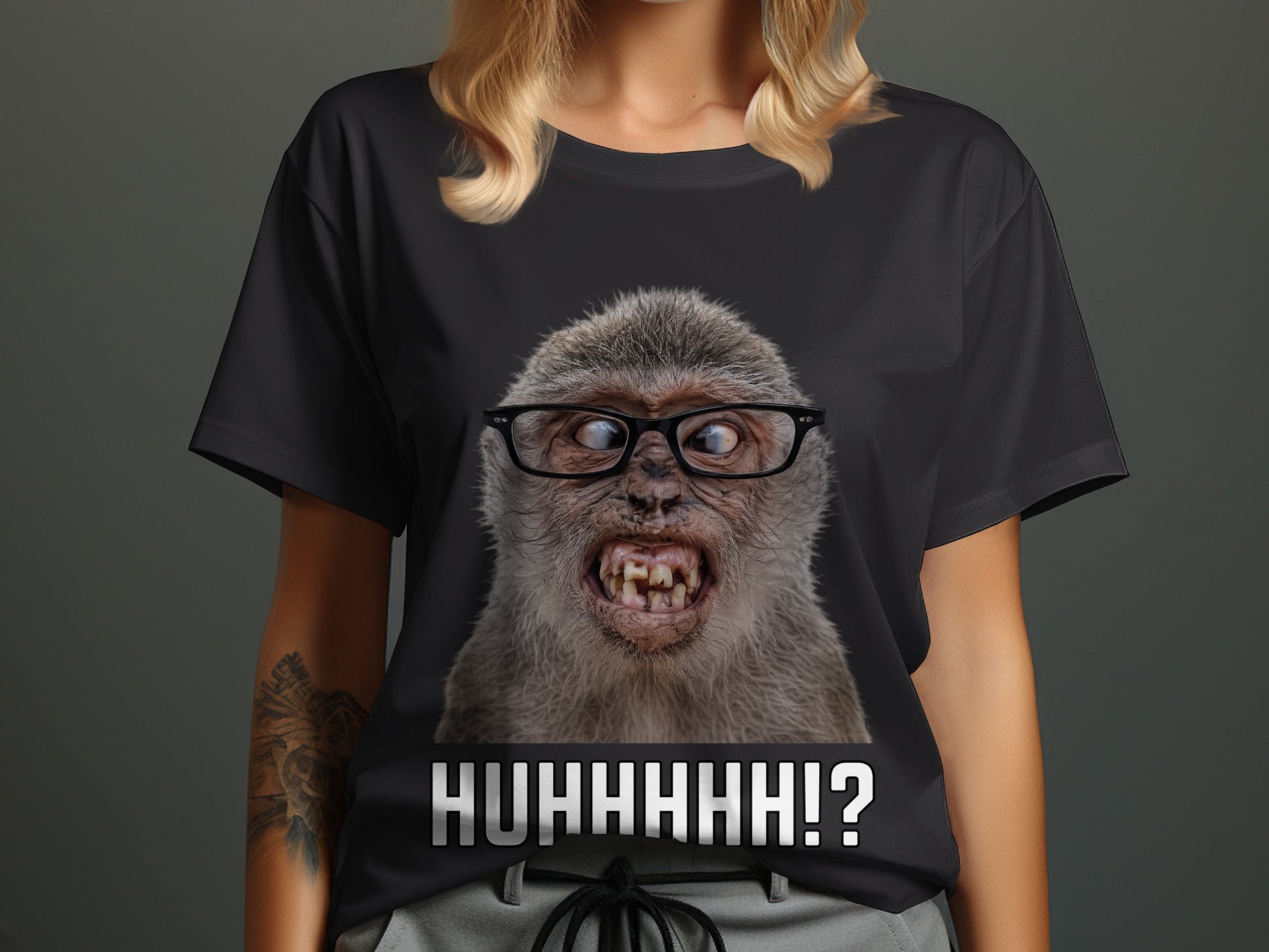Black t-shirt with a close-up of a monkey wearing glasses and text "HUHHHHH!?".