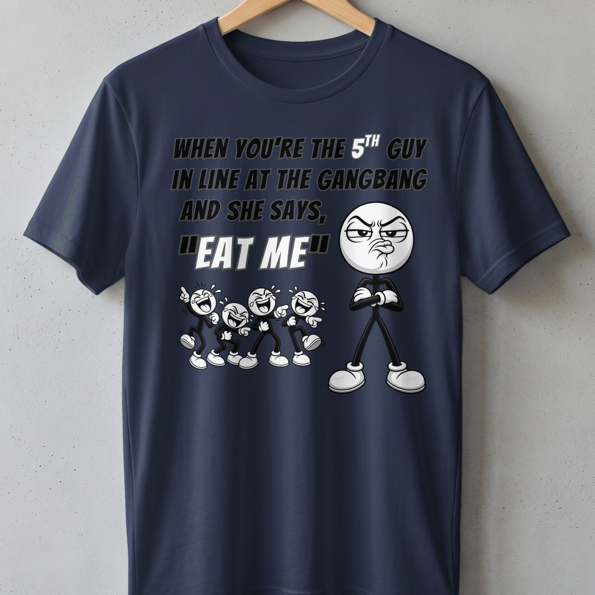 Dark blue t-shirt with text and cartoon characters. "When you're the 5th guy in line at the gangbang and she says, 'Eat me.'"