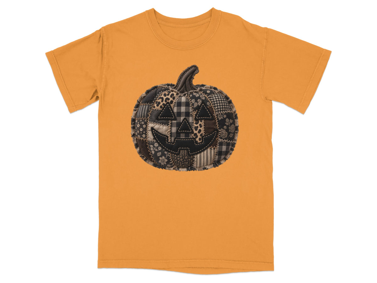 Orange t-shirt with a quilted patchwork jack-o'-lantern graphic.