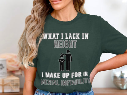 Green t-shirt with text "What I lack in height I make up for in mental instability" and stick figures.