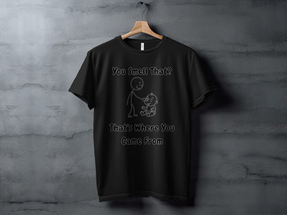 Black t-shirt with line art of a stick figure holding a baby with text "You Smell That? That's Where You Came From".