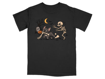 French bulldog runs with bone while skeleton chases on shirt with moon and RIP tombstone.