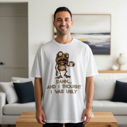 White t-shirt with cartoon zombie holding coffee and text "DAMN.... AND I THOUGHT I WAS UGLY".