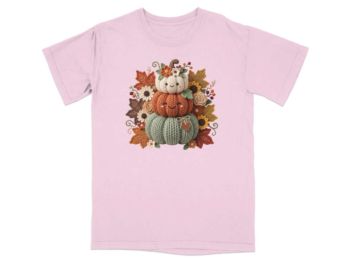 Pink t-shirt with a stacked pumpkin design and autumn leaves.