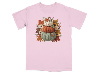 Pink t-shirt with a stacked pumpkin design and autumn leaves.