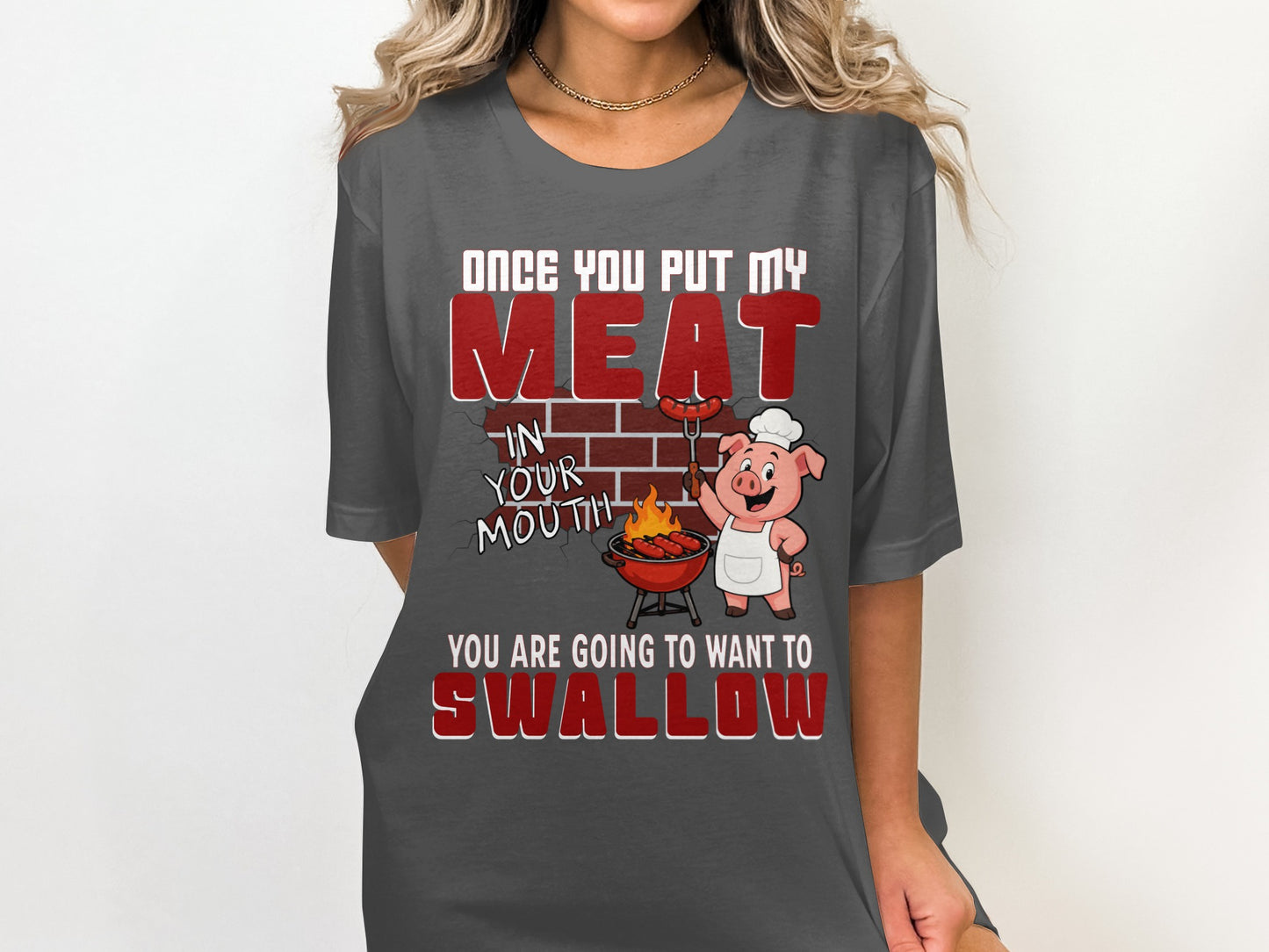 T-shirt graphic with text and cartoon pig grilling sausages.