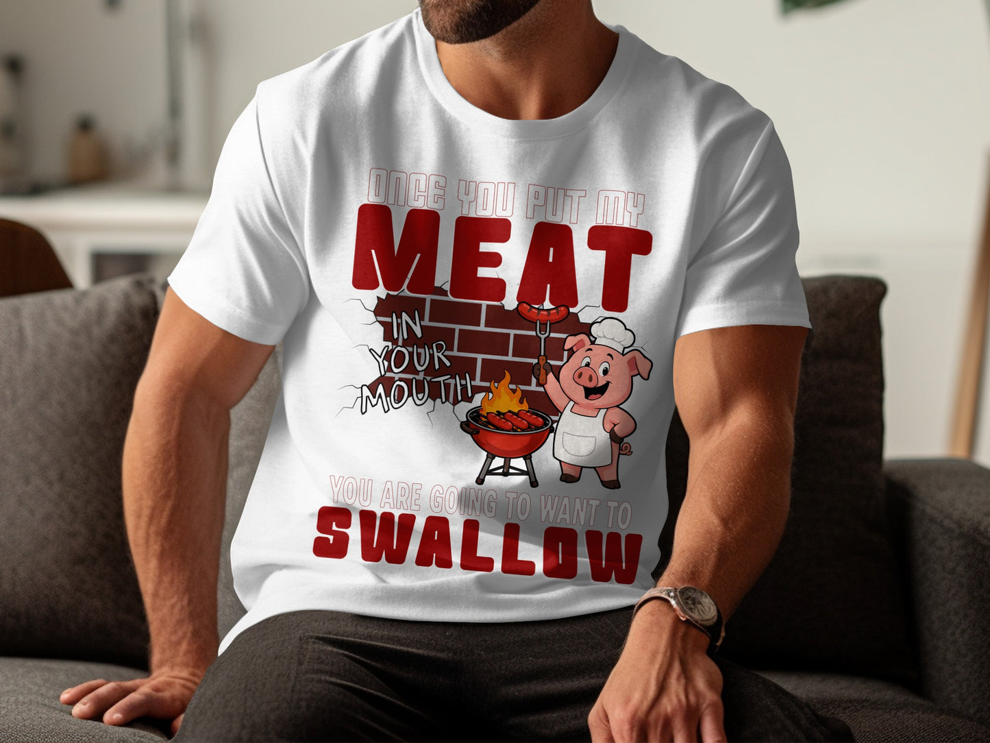 White t-shirt with pig character grilling sausages and text "Once you put my meat in your mouth you are going to want to swallow."