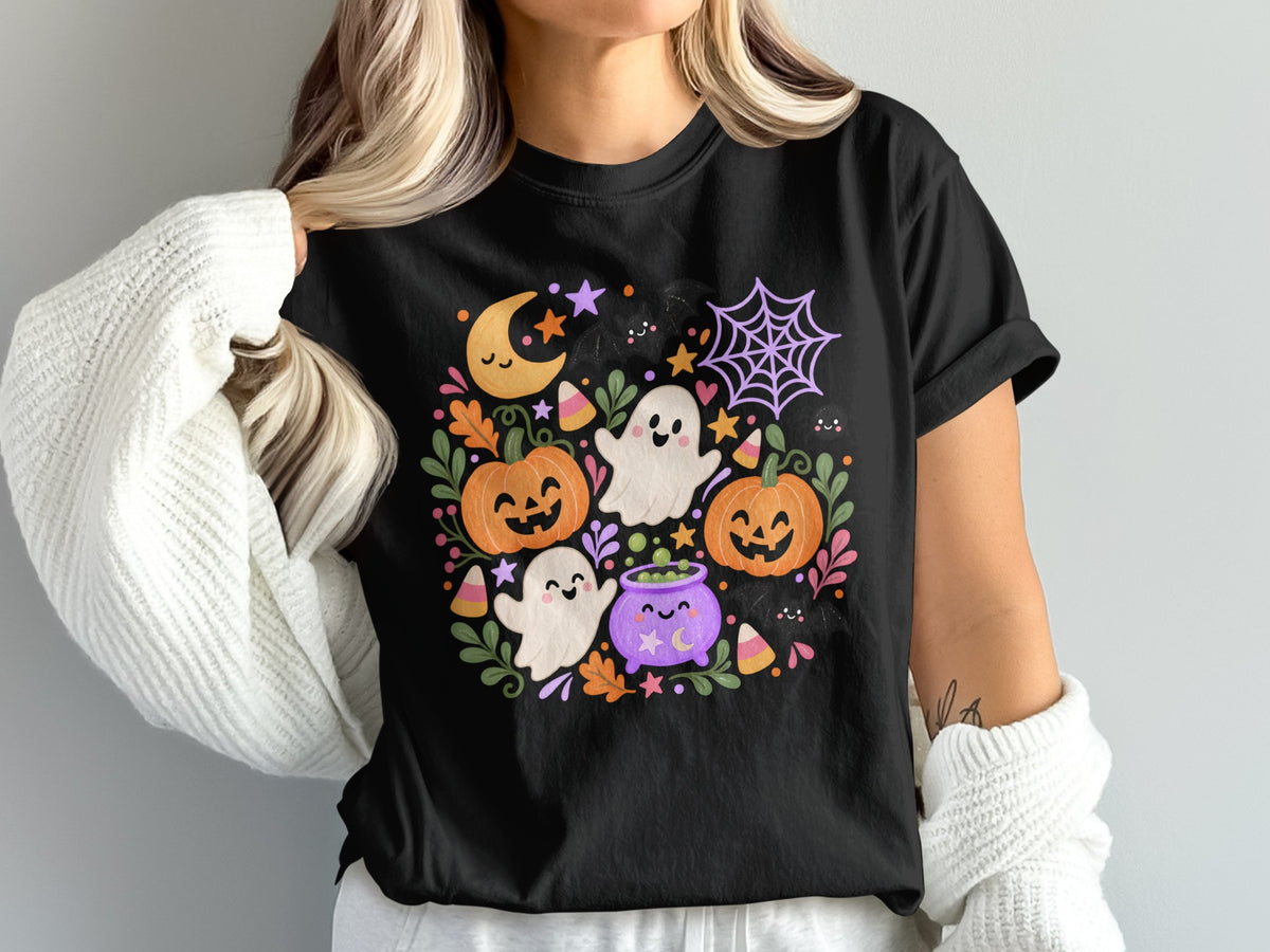 Black t-shirt with colorful Halloween cartoon graphic featuring ghosts, pumpkins, moon, and candy.