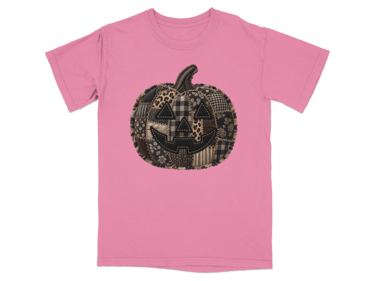 Pink t-shirt with a patchwork jack-o'-lantern graphic.