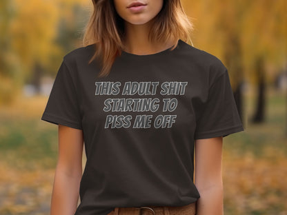 Dark t-shirt with text "THIS ADULT SHIT STARTING TO PISS ME OFF"