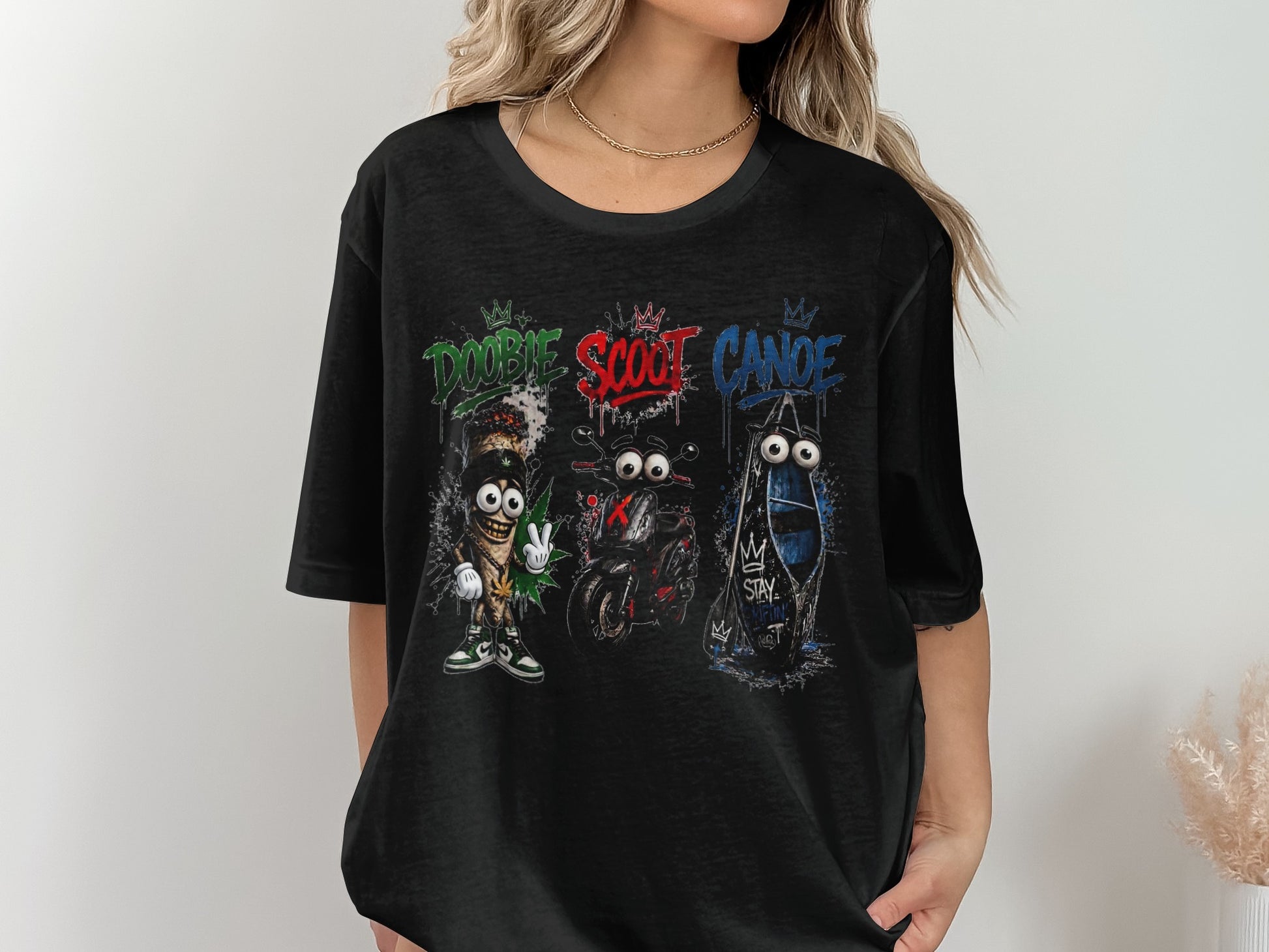 Black t-shirt with Doobie Scout Canoe characters: marijuana joint, scooter, and canoe.