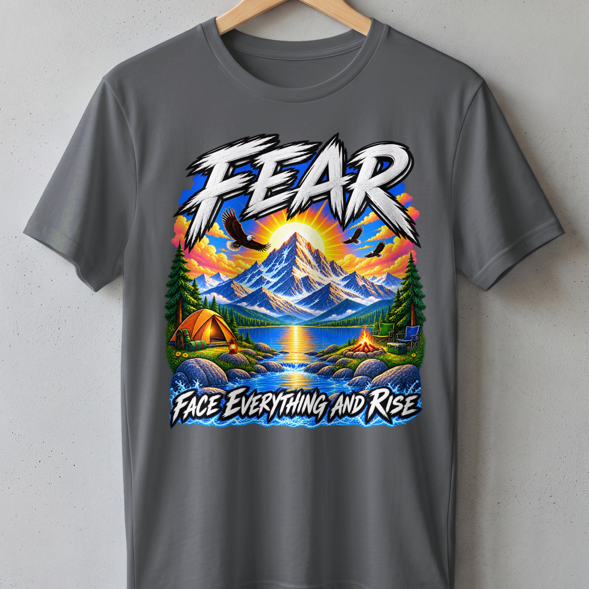 T-shirt graphic with mountains, lake, camping, eagles, and text "FEAR FACE EVERYTHING AND RISE".
