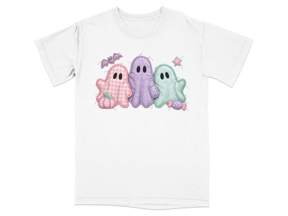 Three pastel ghosts and Halloween themed accents on a white t-shirt.
