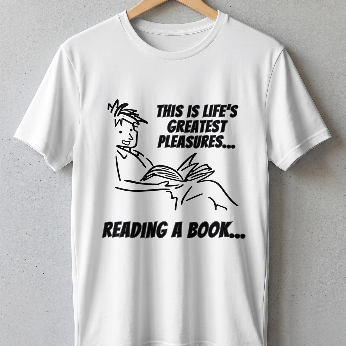 White t-shirt with black line drawing of person reading and text.