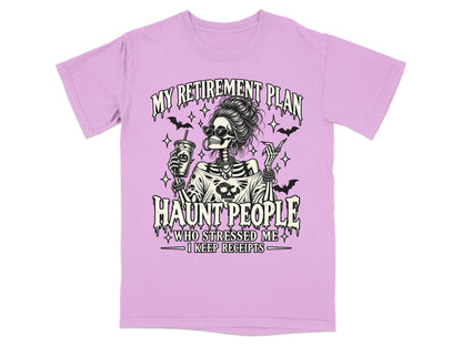 Lilac t-shirt with skeleton graphic and text: "My Retirement Plan Haunt People Who Stressed Me I Keep Receipts."