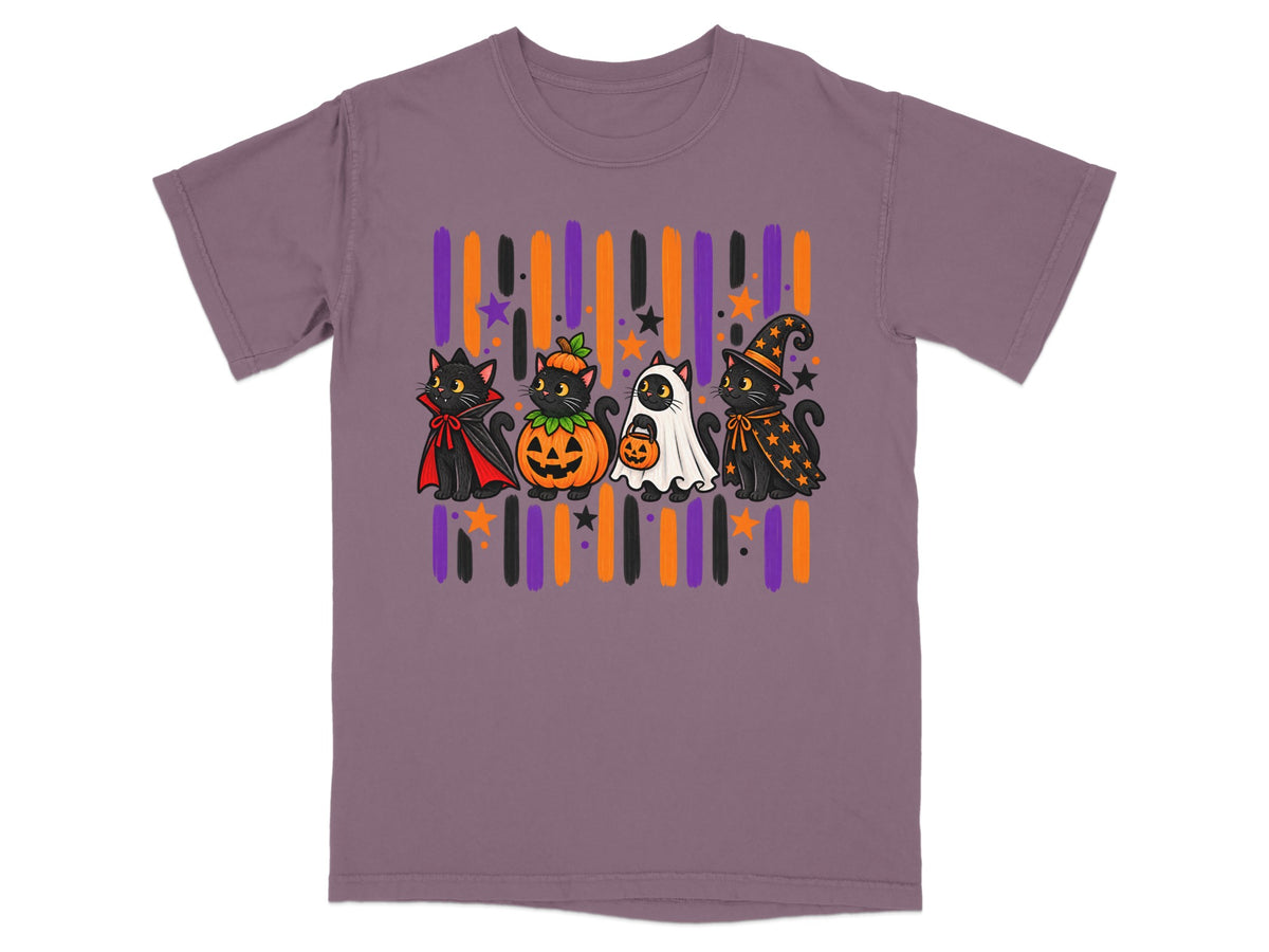 Four cartoon black cats in Halloween costumes on a purple t-shirt.