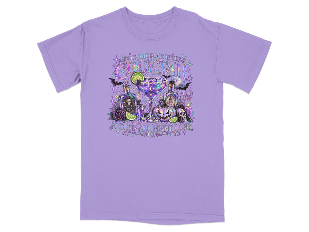 Purple t-shirt with Halloween cocktail graphic featuring "Pour the boos in the cocktail" and "and sip all night long."