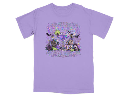 Purple t-shirt with Halloween cocktail graphic featuring "Pour the boos in the cocktail" and "and sip all night long."