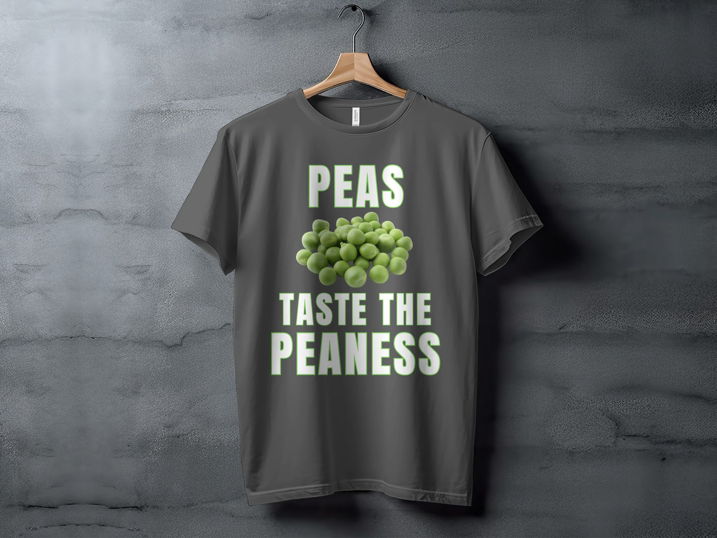 Dark grey t-shirt with text "PEAS TASTE THE PEANESS" and pile of peas.
