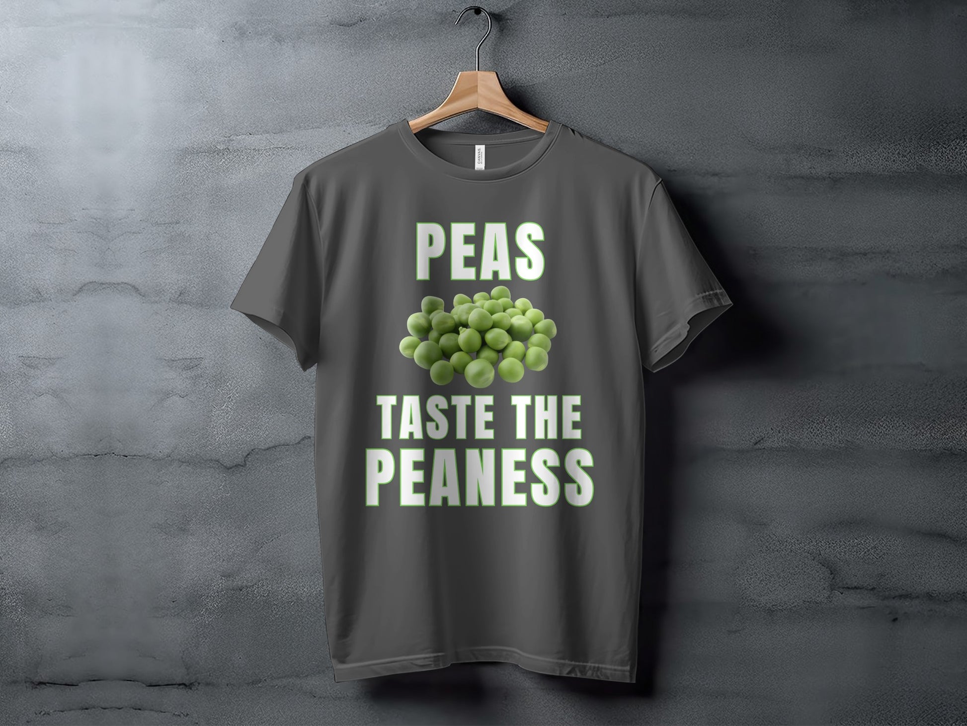 Dark grey t-shirt with text "PEAS TASTE THE PEANESS" and pile of peas.